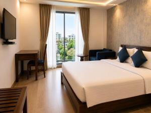 a hotel room with a bed and a television at Hotel Vrindavan Sultanpur in Sultānpur