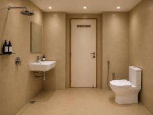 a bathroom with a toilet and a sink at Hotel Vrindavan Sultanpur in Sultānpur +22 photos