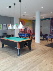 a billiard room with a pool table in it at Astor Garden Hotel in Saints Constantine and Helena