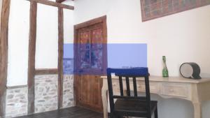 a room with a desk and a wooden door at Odyssée auvergne in Vallon-en-Sully