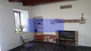 a dining room with a table and a fireplace at Odyssée auvergne in Vallon-en-Sully