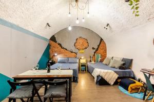 a room with a bed and a table in a room at Casa Velata a Spaccanapoli in Naples