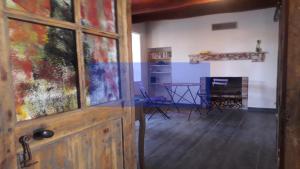 a door in a room with a table and chairs at Odyssée auvergne in Vallon-en-Sully