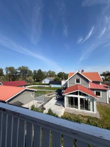 a house with red roofs and a white fence at Grevgatan 4 Apt 1101 in Eksjö