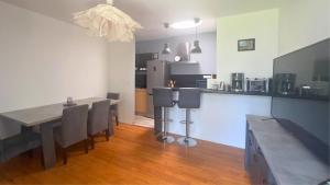 a kitchen and dining room with a table and chairs at Domaine de ferrabouc in Mas-Saintes-Puelles
