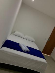 a bed in a room with two towels on it at Pousada Monteiro Surubim in Surubim