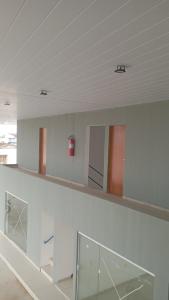 a room with white walls and a shelf with windows at Pousada Monteiro Surubim in Surubim