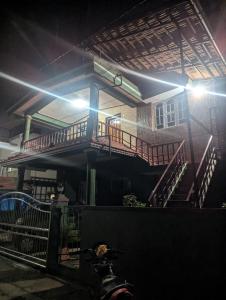 a building with a staircase in front of it at Coorg homes in Madikeri +4 photos