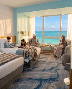 a group of people sitting in a hotel room at Symphony Style Hotel Kuwait in Kuwait
