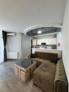 a living room with a couch and a coffee table at Ideal home in Minda