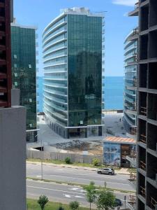 a view of two tall buildings and the ocean at Ideal home in Minda