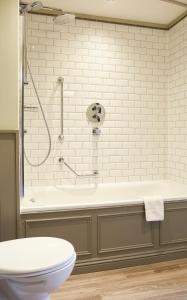 a bathroom with a shower and a tub with a toilet at Swan Hotel by Greene King Inns in Alton