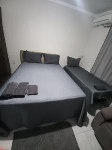 a bedroom with a large bed and a couch at Apartamento 102 até 9 pessoas com garagem in Ipatinga