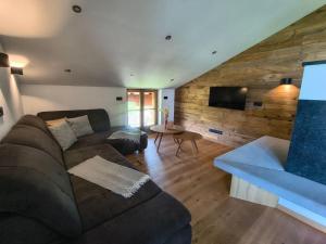 a living room with a couch and a tv at biohof Stiedler in Sankt Johann in Tirol