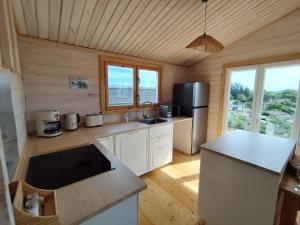 a kitchen with a refrigerator and a counter top at Le chalet d'Agathe in Largentière