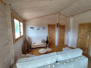 a living room with a couch and a table at Le chalet d'Agathe in Largentière