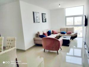 a living room with a couch and a chair at Atlantis Tower in Santa Cruz de la Sierra