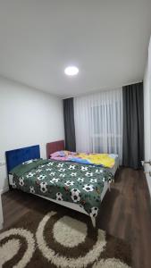 a bedroom with a bed with a cow blanket at Pines Apartment in Kosovo Polje