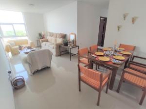 a living room with a dining table and chairs at Atlantis Tower in Santa Cruz de la Sierra