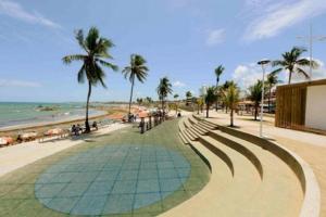a sandy beach with palm trees and the ocean at Hostel salvador itapua in Salvador