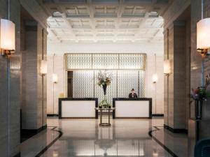 a man sitting at a desk in a lobby at Sofitel Lafayette Square Washington DC in Washington, D.C.