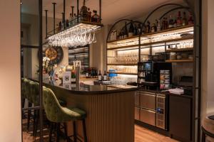 a bar in a restaurant with a counter and stools at Hotel zum Kaiserdom in Speyer