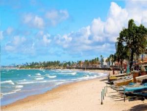 a sandy beach with boats and the ocean at Hostel salvador itapua in Salvador