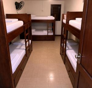 a room with three bunk beds in a room at Hostel salvador itapua in Salvador
