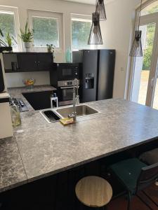 a kitchen with a sink and a counter top at Bellavita in Courpière