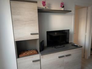 a living room with a flat screen tv on a wall at Casa Paloma Free Parking in Bolsena