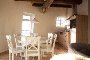eine Küche und ein Esszimmer mit einem Tisch und Stühlen in der Unterkunft Het Torentje van Trips in Tripscompagnie