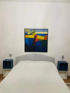 a bedroom with a white bed and two blue night stands at Villa Bignago B&B in Arquà Petrarca +20 photos