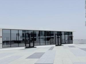 an external view of a building with large windows at Ajmal Makan City in Sharjah