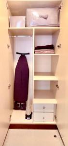 a white closet with a dresser and a bag at Ajmal Makan City in Sharjah +4 photos