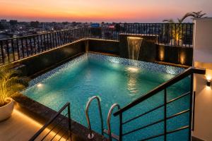 a swimming pool on top of a building at Hotel Nayyar Regency Near Golden temple in Amritsar
