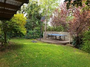 a picnic table on a wooden deck in a park at SnirBen zvi in Kibbutz Snir