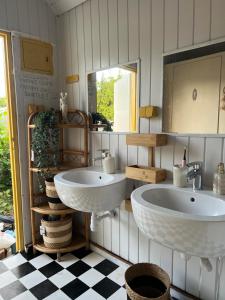 a bathroom with two sinks and a mirror at Przyczepa Kempingowa Beige in Jastarnia +6 photos
