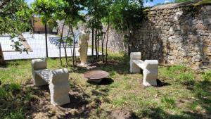 a statue of a man standing next to a stone wall at VILLA SAINT PIERRE in La Trimouille