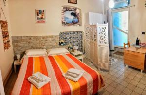 a bedroom with a bed with two towels on it at La MARUZZELLA in Vietri sul Mare
