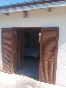 a door into a room with a bed in it at Lo de Rolo in Huerta Grande +3 photos