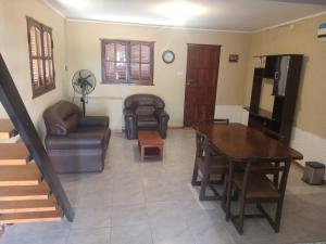 a living room with a couch and a table at Lo de Rolo in Huerta Grande
