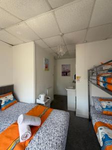 a room with two beds and a sink in it at Suncrest Hotel # Self-check-in in Blackpool +29 photos