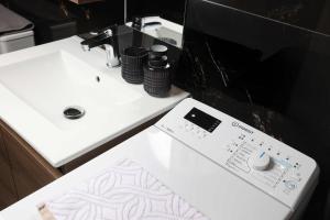 a remote control sitting on a counter next to a sink at Living in in Afitos +9 photos