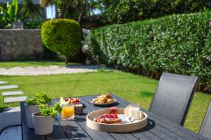 a table with a tray of breakfast food on it at Living in in Afitos