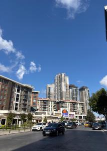 a city street with cars parked in front of tall buildings at Huzur Otel Ümraniye in Istanbul
