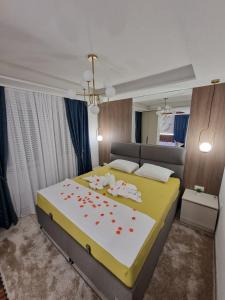a bedroom with a large bed with red flowers on it at Centar Spa Teslic in Teslić