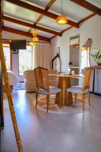 a living room with a wooden table and chairs at Fruto Vermelho Pousada in Pedra Menina