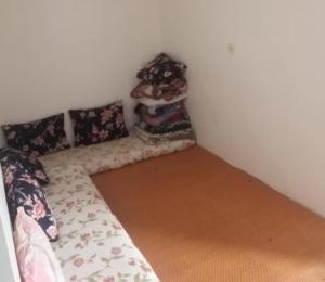 a bed in a corner of a room with a stuffed animal at colomina in Sidi Ifni