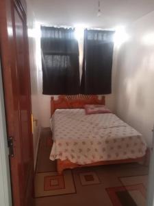 a small bed in a room with a window at colomina in Sidi Ifni