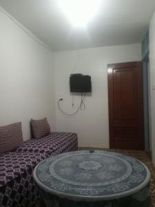 a room with a table and a bed and a tv at colomina in Sidi Ifni